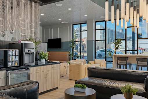 a living room with couches and a kitchen and a table at SevenO2 Main Apartments, Salt Lake City, Utah