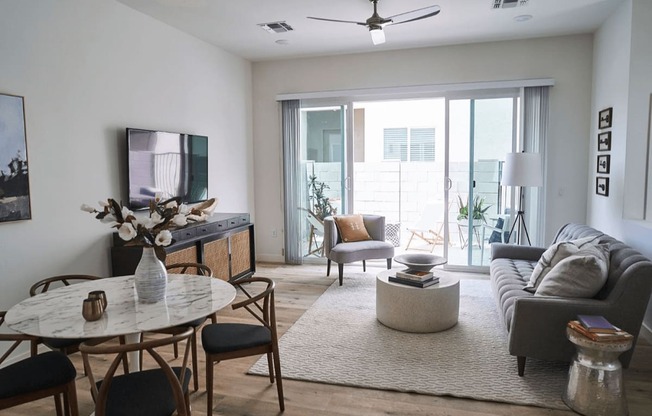 a living room with a couch and a table at Novella Biltmore, Phoenix, 85016