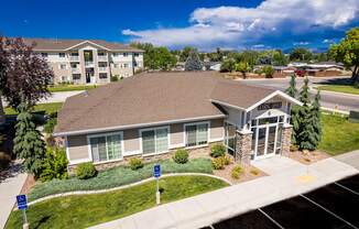 A building with a brown roof and a sign that says "Welcome" in front of it.