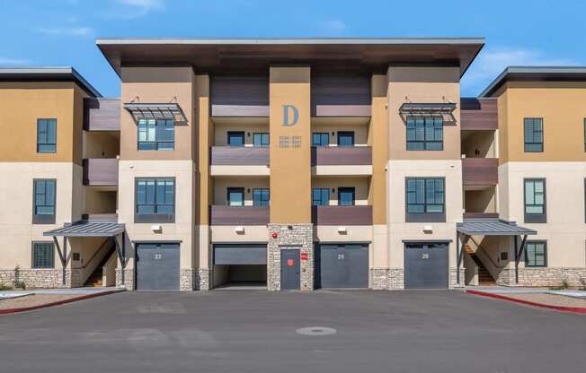 a building with a parking lot in front of itat Solace at Ballpark Village, Goodyear, AZ, 85338