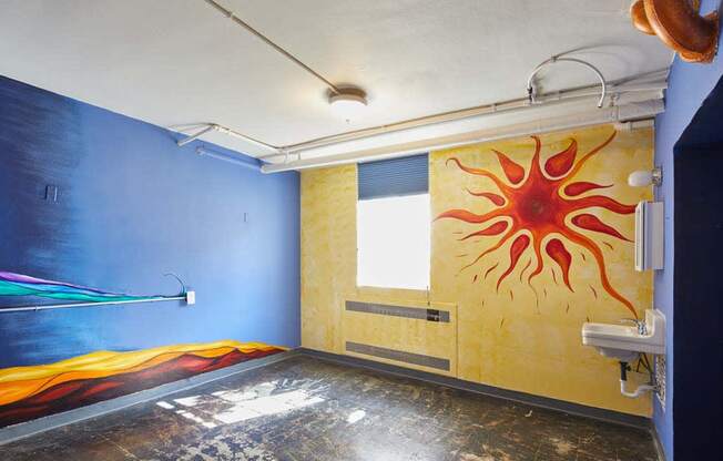 a mural of a sun on a wall in a room at MILEPOST 5 Apartments, PORTLAND Oregon
