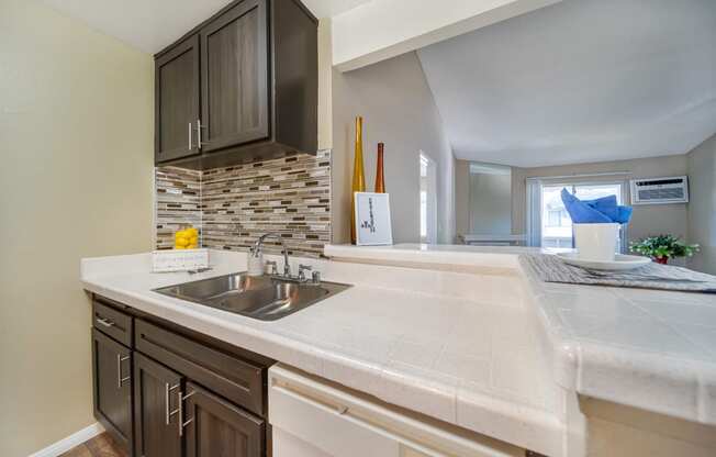 an empty kitchen with a sink and a window