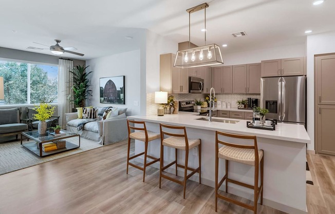 a kitchen and living room in an open floor planat Weylyn Luxury Apartments, Laveen, AZ