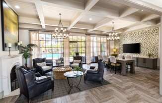 a living room with a fireplace and a table with chairs