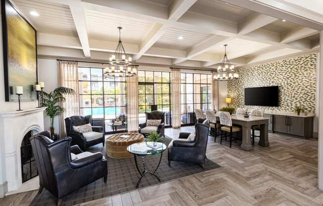 a living room with a fireplace and a table with chairs