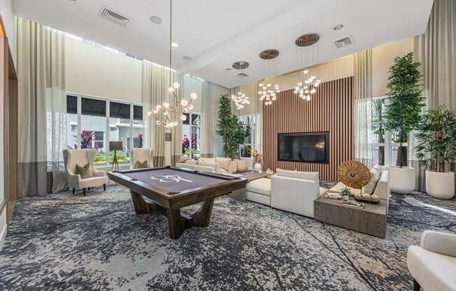 a living room with a pool table in the center