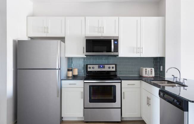 kitchen with stainless steel appliances and white cabinets