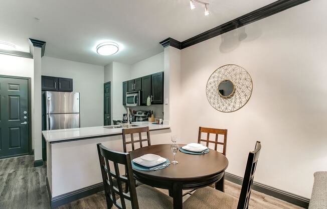 a dining room and kitchen with a table and chairs