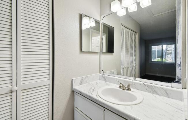 a bathroom with a sink and a mirror