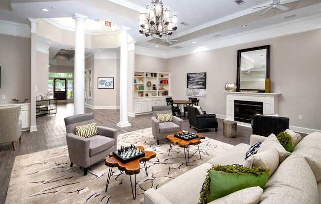 A living room with a fireplace and a chess board on the coffee table.