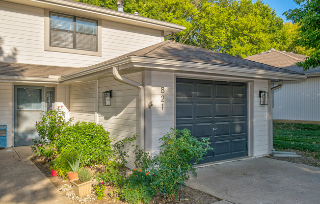 Townhome exterior view of garage and front door at The Arbor in Blue Springs, Missouri