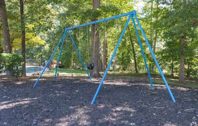 a swing set in a playground in a park