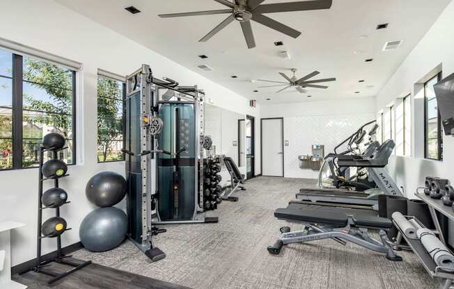 a gym with weights and a ceiling fan at Grandstone at Sunrise, Peoria, AZ