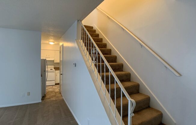 large carpeted room with stairs