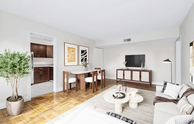 A living room with a white couch, a coffee table, and a potted plant.