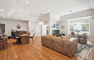 a living room with a couch and a desk
