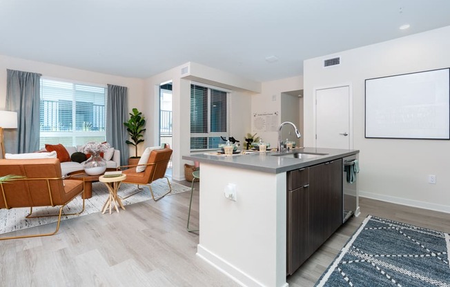 A modern kitchen with a dining table and chairs.