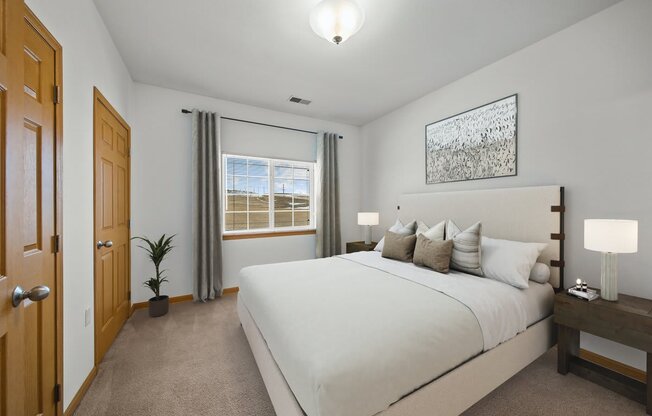 a bedroom with a large bed and a window