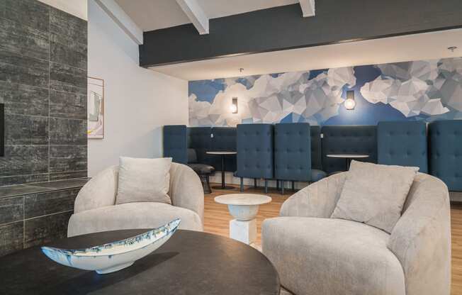 a living room with couches and chairs and a table with a bowl