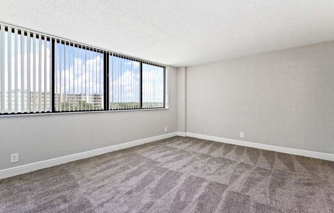 an empty living room with a large window