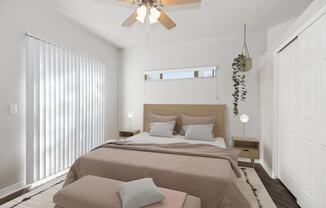 a bedroom with a large bed and a ceiling fan