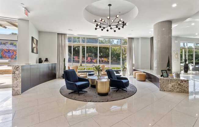 a lobby with a table and chairs and a large window