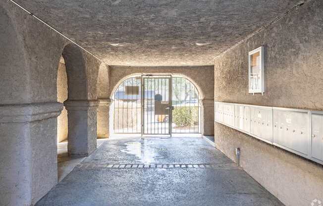 A tunnel with a metal gate at the end.