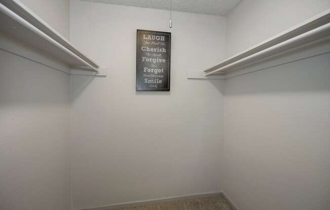 a room with two shelves and a sign on the wall