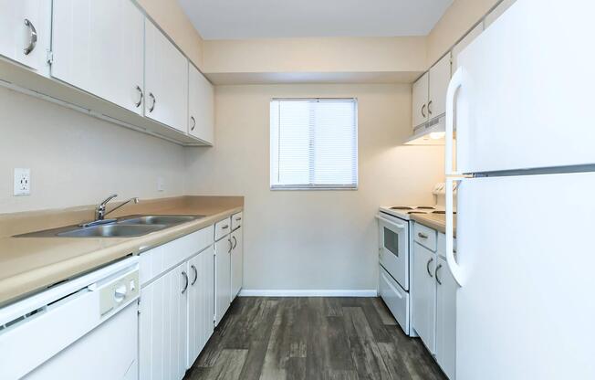 a kitchen with a sink and a refrigerator