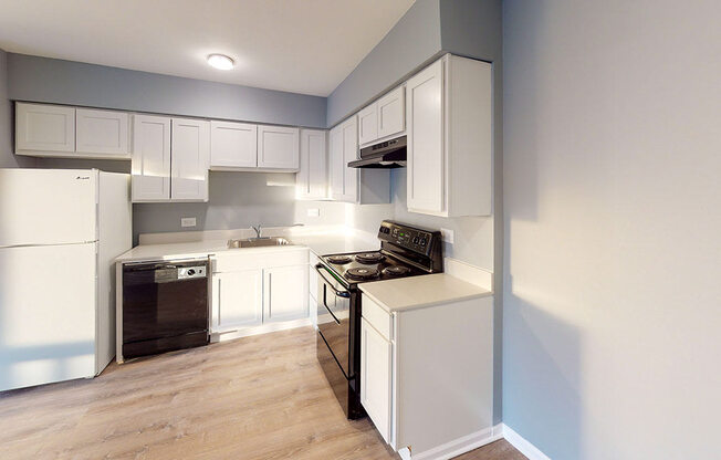 a kitchen with white cabinets and a stove and a refrigerator