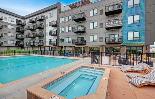 a swimming pool in front of an apartment building