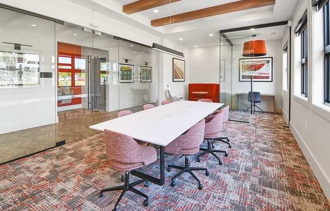 a conference room with a white table and chairs