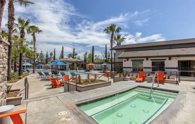 Outdoor pool and jacuzzi area with seating