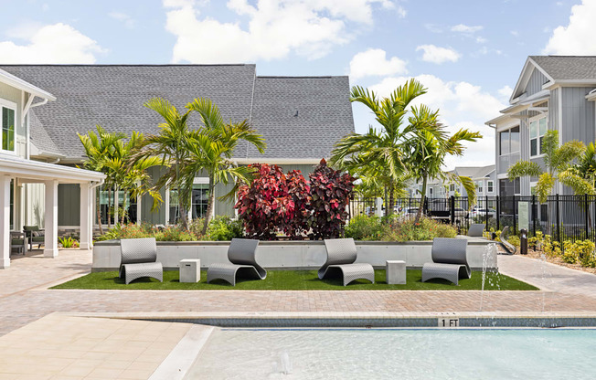 a yard with a pool and furniture in front of a house at Palm Grove in Ellenton, FL 34222