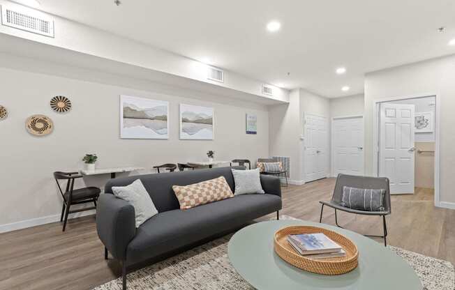 a living room with a couch and a table at Switchback on Platte Apartments, Littleton, CO