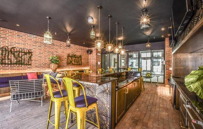 A restaurant with a bar area and a brick wall.