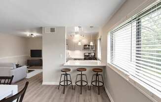 A kitchen with a bar stool and a countertop.