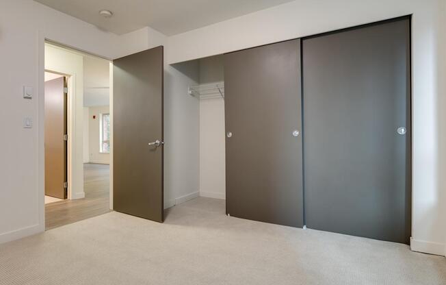 A room with a brown door and a white door.