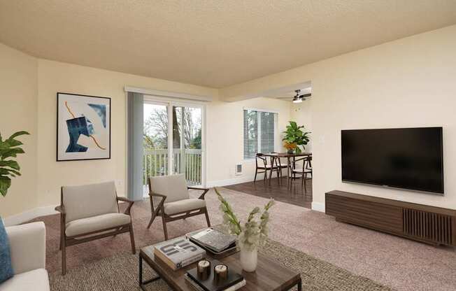 A living room with a television, chairs, and a coffee table.
