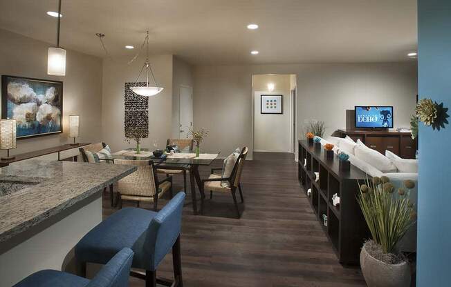 a living room and dining room with a table and chairs