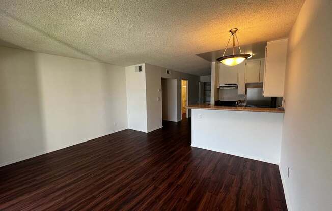 A room with wooden floors and white walls.