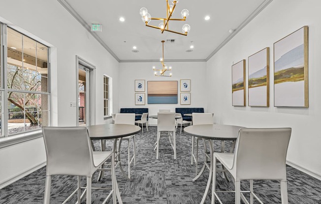 A conference room with a table, chairs, and pictures on the wall.