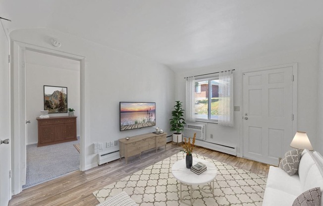 a living room with white walls and a white couch