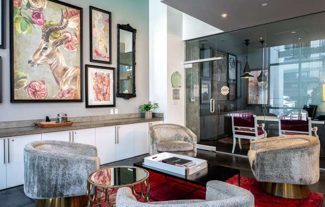 a living room with chairs and a coffee table and a kitchen