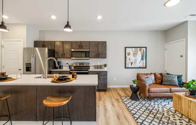 a living room with a kitchen and a couch at EagleRidge Plaza Residences, Fargo, North Dakota