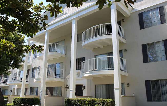 A white apartment building with balconies and windows.