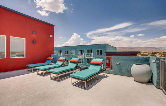 A red building with a blue building in the background and a white vase on the right.