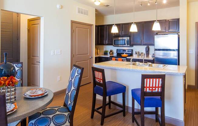 a kitchen with a large island with a breakfast bar