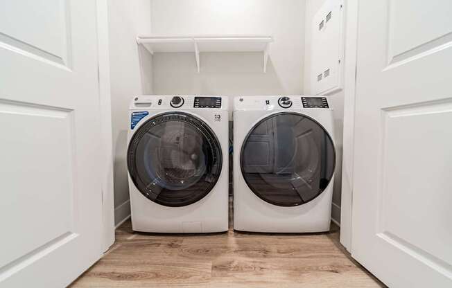 Two front loading washing machines in a laundry room.
