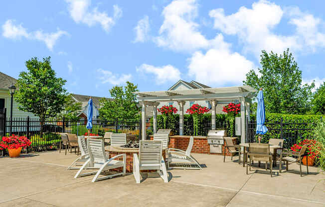 an outdoor patio with tables and chairs and a gazebo